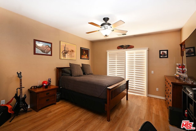 bedroom with ceiling fan and light hardwood / wood-style flooring