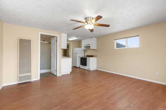 unfurnished living room featuring wood-type flooring, a textured ceiling, and ceiling fan