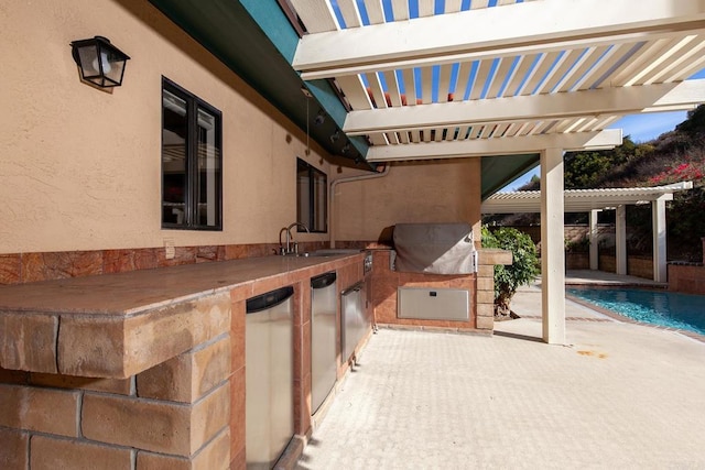 view of patio / terrace with area for grilling, a grill, a pergola, and sink