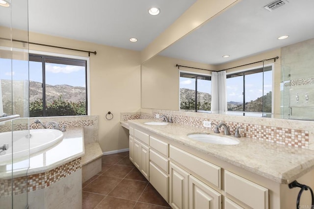 bathroom featuring vanity, a mountain view, plenty of natural light, and tile patterned floors