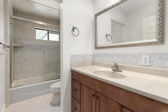 full bathroom featuring bath / shower combo with glass door, vanity, and toilet