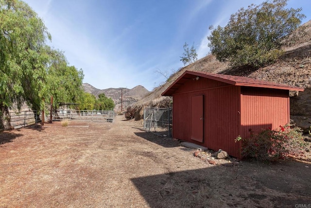 view of yard with a mountain view and a storage unit