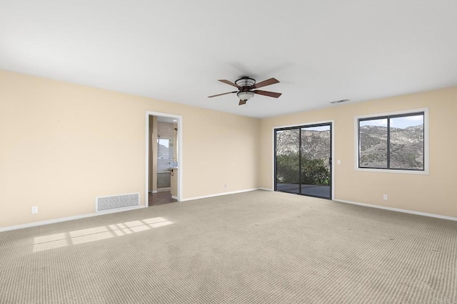 unfurnished room featuring light colored carpet and ceiling fan