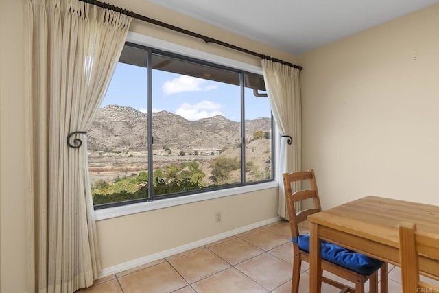 dining area with a mountain view and light tile patterned floors