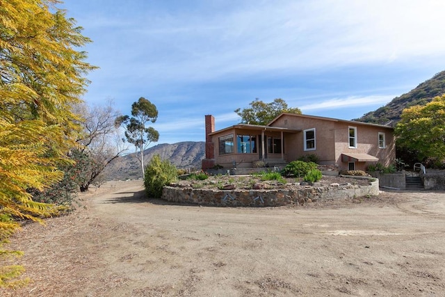 rear view of property with a mountain view