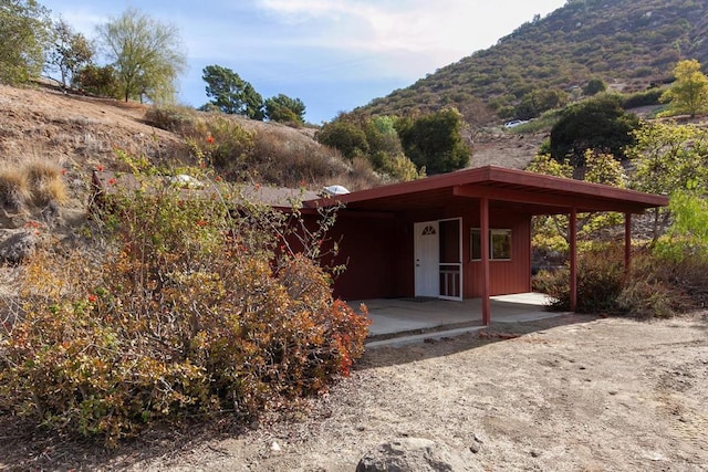 exterior space featuring a mountain view and a patio area