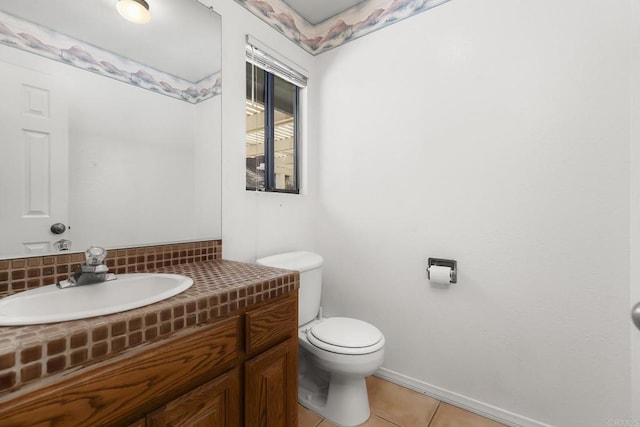 bathroom featuring vanity, tile patterned floors, and toilet