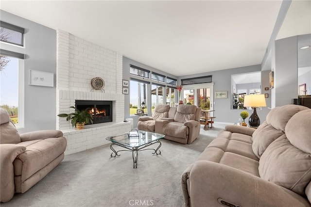 carpeted living room with a fireplace