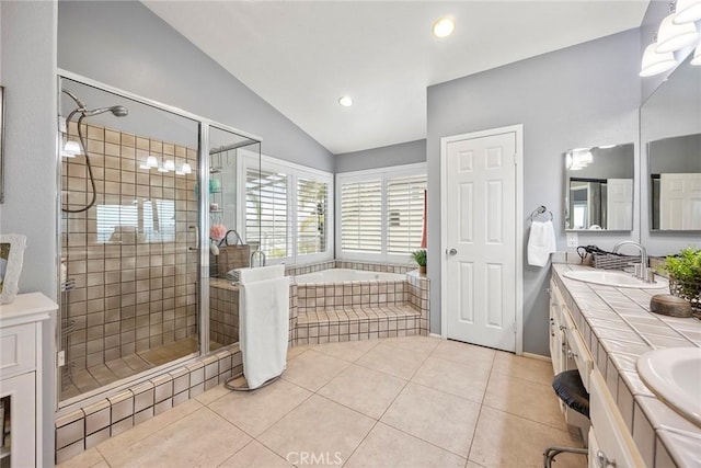 bathroom with tile patterned floors, lofted ceiling, plus walk in shower, and vanity