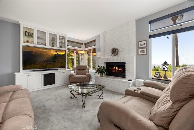 living room featuring light carpet and a brick fireplace