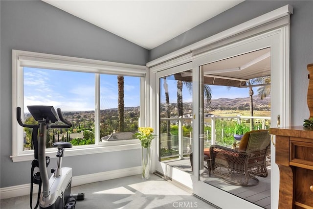 sunroom / solarium featuring a mountain view and lofted ceiling