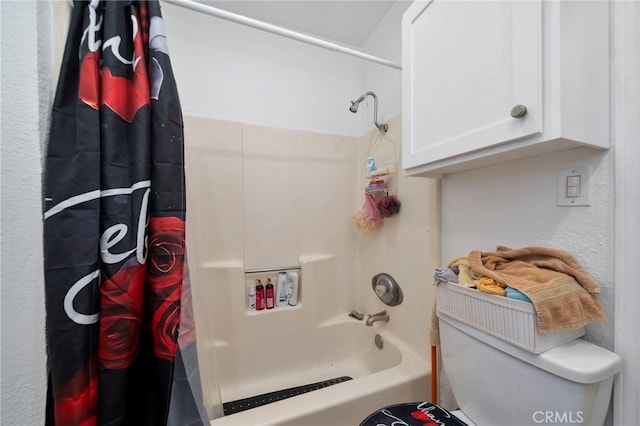 bathroom featuring shower / bath combination with curtain and toilet