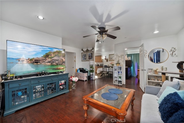 living room with ceiling fan and dark hardwood / wood-style flooring