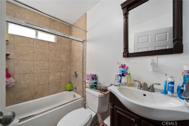 full bathroom with vanity, toilet, and tiled shower / bath combo