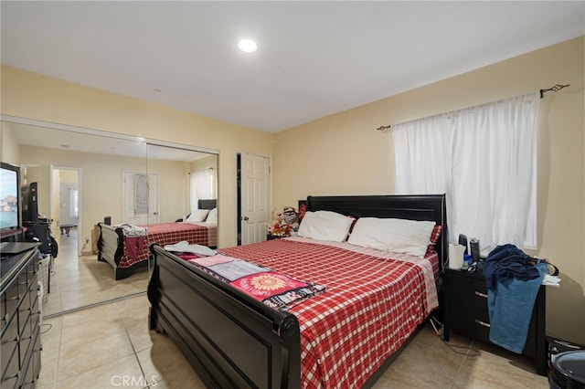 tiled bedroom featuring a closet