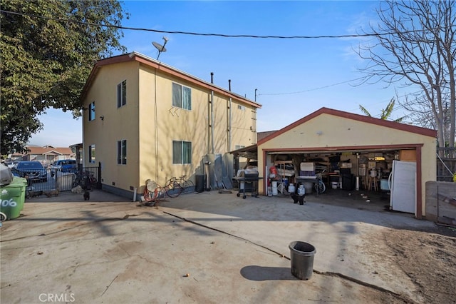 exterior space featuring a garage and an outbuilding