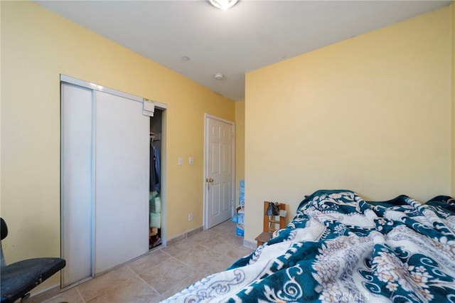 tiled bedroom with a closet