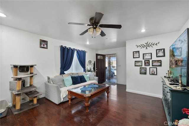 living room featuring ceiling fan and dark hardwood / wood-style flooring