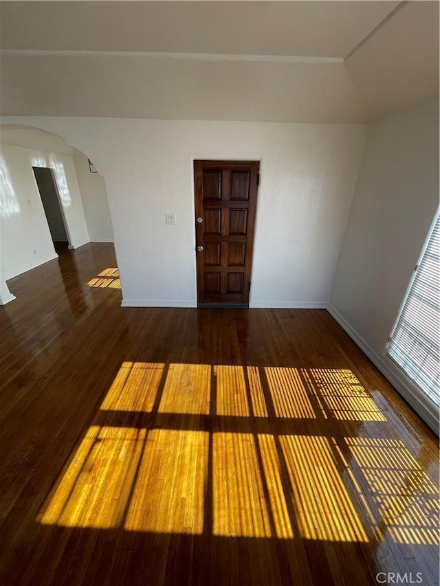 spare room featuring dark wood-type flooring