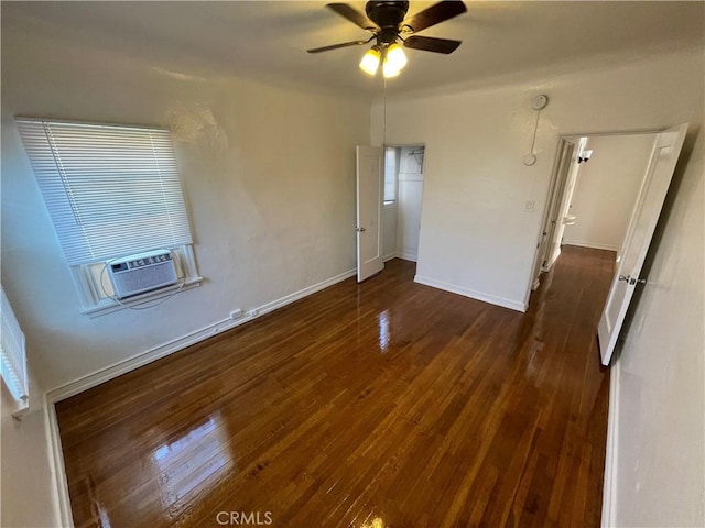 spare room featuring cooling unit, dark wood-type flooring, and ceiling fan