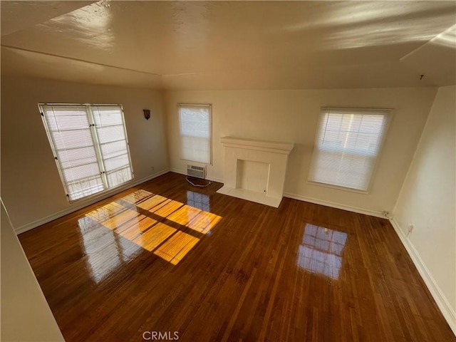 unfurnished living room with dark hardwood / wood-style floors