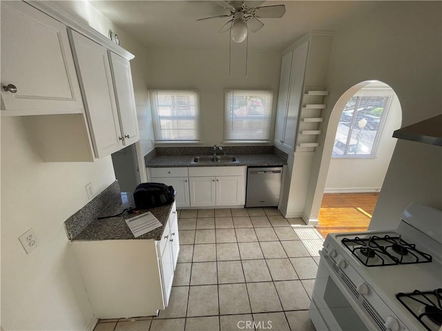 kitchen featuring sink, light tile patterned floors, white range with gas stovetop, white cabinetry, and stainless steel dishwasher