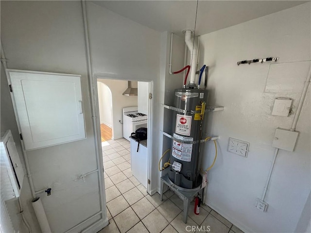 utility room featuring strapped water heater and washer / dryer