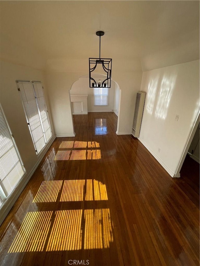 interior space featuring a notable chandelier and dark wood-type flooring