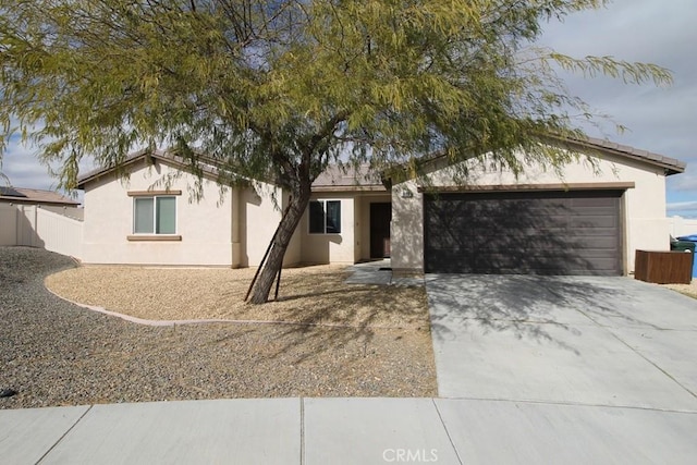 913 Wren Ct, Barstow, CA 92311 - ranch-style house with stucco siding, concrete driveway, and a garage