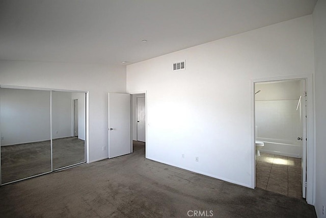 913 Wren Ct, Barstow, CA 92311 - unfurnished bedroom with carpet flooring, a closet, and vaulted ceiling