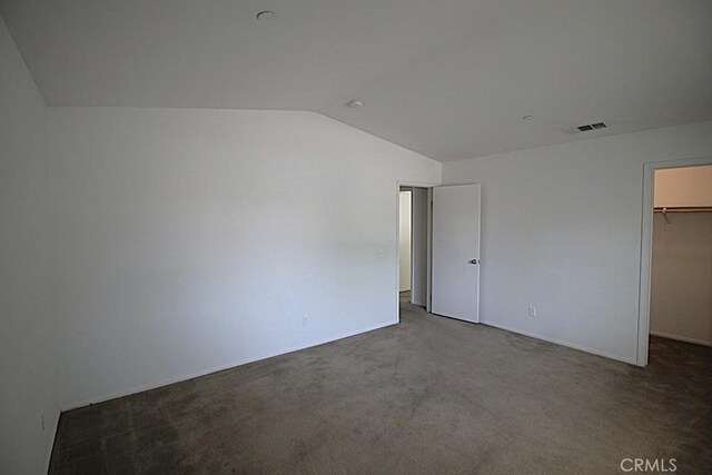 913 Wren Ct, Barstow, CA 92311 - unfurnished bedroom with lofted ceiling, a walk in closet, carpet, and a closet