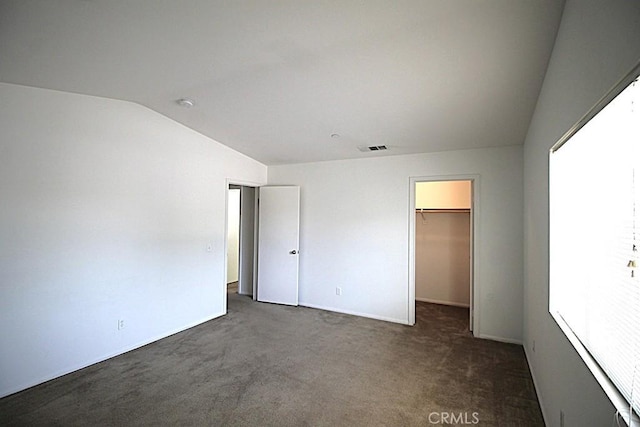 913 Wren Ct, Barstow, CA 92311 - unfurnished bedroom featuring vaulted ceiling, carpet flooring, a walk in closet, and baseboards