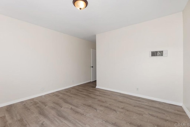 spare room with hardwood / wood-style floors