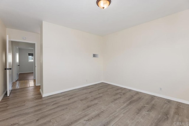 spare room featuring light hardwood / wood-style flooring