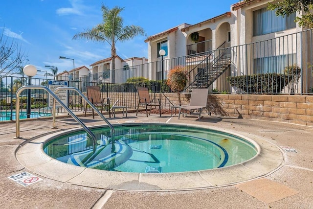 view of pool with a hot tub