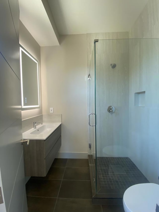 bathroom with walk in shower, vanity, toilet, and tile patterned flooring