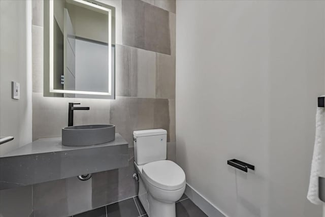 bathroom with tile patterned floors, toilet, and sink