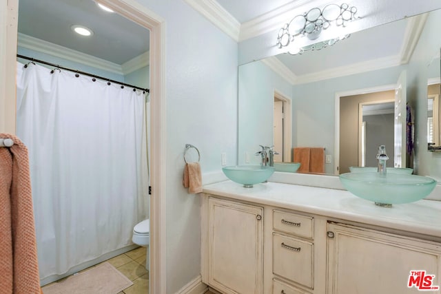 bathroom featuring tile patterned flooring, vanity, crown molding, and toilet