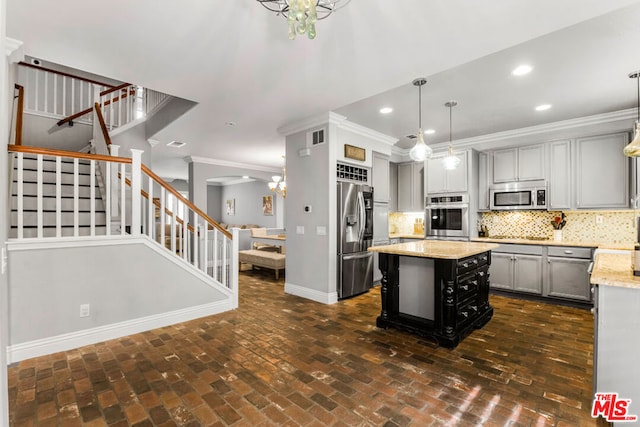 kitchen with gray cabinets, stainless steel appliances, ornamental molding, decorative backsplash, and decorative light fixtures