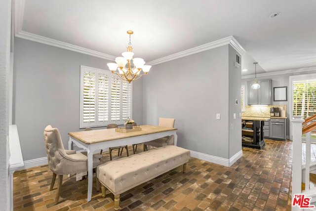 dining area with crown molding and an inviting chandelier