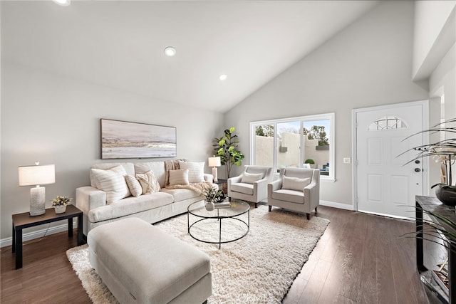 living room featuring dark wood-type flooring and high vaulted ceiling