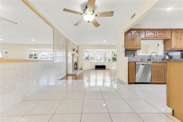 kitchen with dishwasher, plenty of natural light, ornamental molding, and light tile patterned floors