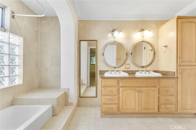 bathroom with crown molding, tile patterned floors, vanity, and a bathtub