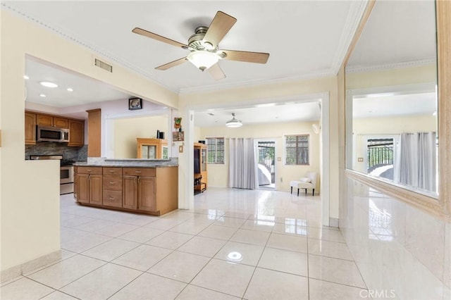 kitchen featuring ornamental molding, light tile patterned floors, ceiling fan, and decorative backsplash