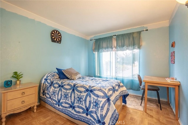 bedroom with light parquet flooring