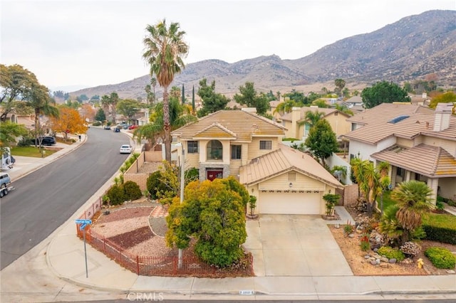 view of front of home with a garage and a mountain view