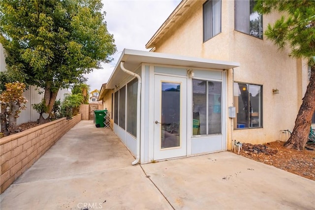 view of side of home with a patio