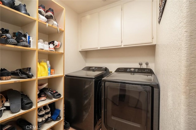 laundry room featuring cabinets and washer and dryer