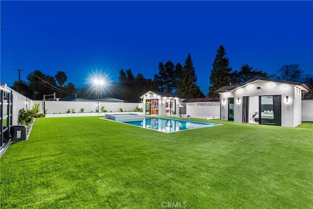 view of yard with an outbuilding and a fenced in pool