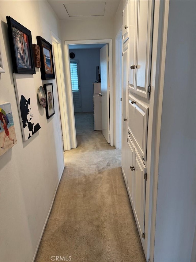 hallway with light colored carpet